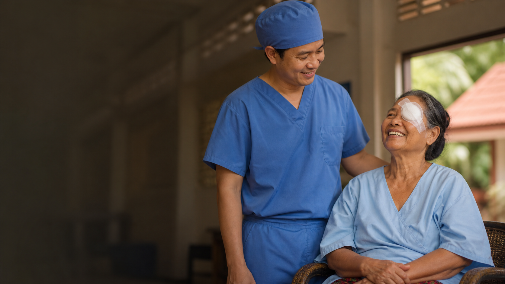 A Cambodian patient smiling with her ophthalmologist after sight-restoring surgery